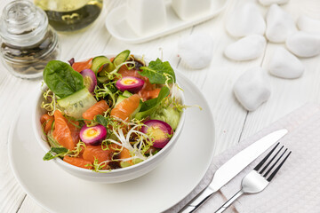Salmon salad on a white wooden table
