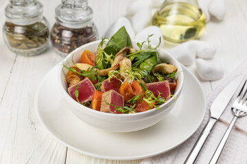 Tuna salad on a white wooden table
