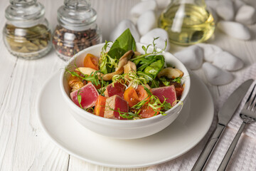 Tuna salad on a white wooden table
