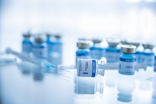 Ampoules with Covid-19 vaccine. Syringe with needle. Fighting the covid-19 virus.
