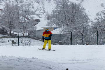 Snowboarder in the Caucasus mountains in winter. Snowy day in Tufandag Resort. Gabala- Azerbaijan