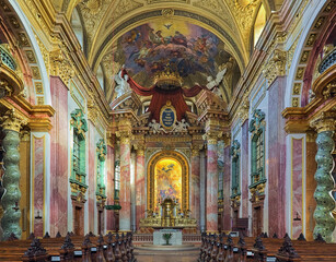 Fototapeta na wymiar Vienna, Austria. Choir and altar of Jesuit Church or University Church. The church was built in 1623-1627. It was remodeled in 1703-1705 by Andrea Pozzo, who also executed the altarpiece and fresco.