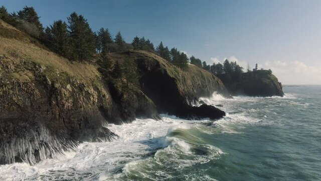 Aerial View of Waves Crashing in Air at Cape Disappointment with Lighthouse
