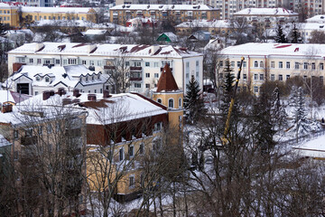 Fototapeta na wymiar Winter, snow city view from the top. Streets, buildings, cars. Gomel, Belarus.