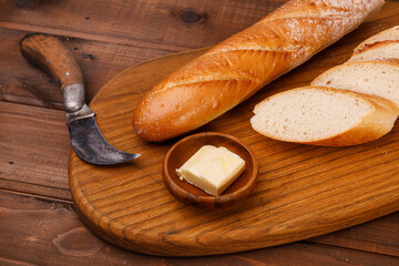 Fresh baguette bread on wooden background