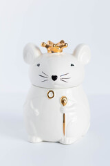 White porcelain rat princess in a golden crown.