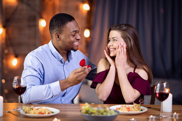 Happy African American Man Making Proposal To His Surprised White Girlfriend