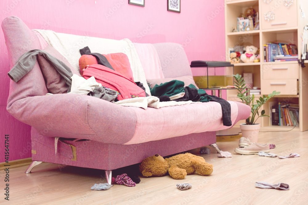 Wall mural Room of a teenage girl with scattered clothes and things. The concept of a mess, general cleaning.