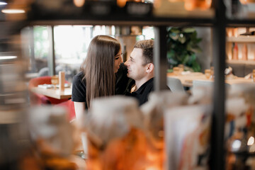 happy loving couple guy and girl on a date in a cafe