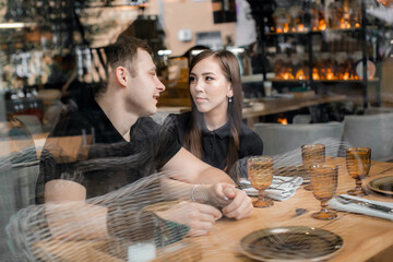 happy loving couple guy and girl on a date in a cafe
