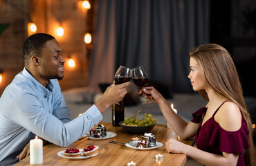 Happy Black Man And White Woman Having Romantic Dinner In Restaurant