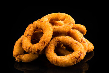 Delicious fried onion rings on table, closeup