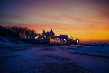 small  resort restaurant and hotel in the winter evening at sunset