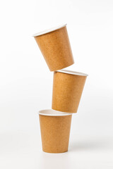 three balancing disposable paper cups