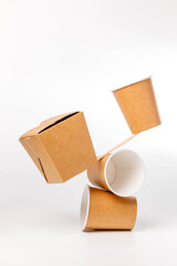 disposable paper box and cups balancing on wooden knife