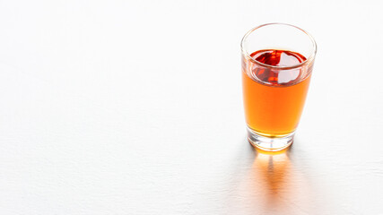 glass of alcohol on white background with place for text