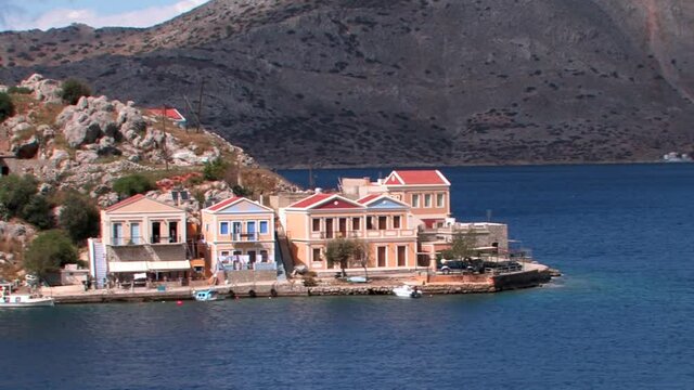 Symi Greece Rhodes is a Greek island It is mountainous and includes the harbor town of Symi and its adjacent upper town Ano Symi, with beautiful neoclassical uniform and colorful houses