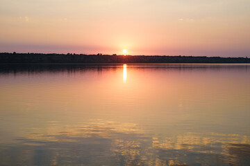 Summer landscape with reflection of colorful sunset in the lake