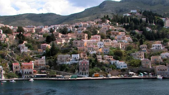 Symi Greece Rhodes is a Greek island It is mountainous and includes the harbor town of Symi and its adjacent upper town Ano Symi, with beautiful neoclassical uniform and colorful houses
