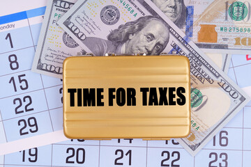 On the table lies a calendar, money and a briefcase with the inscription - TIME FOR TAXES