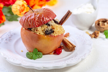 Baked spicy apple with couscous and dried berries.