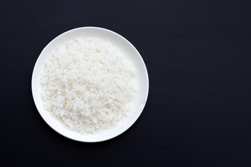 Dish of rice on dark background.