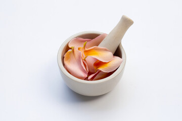 Plumeria or frangipani flower petals in mortar with pestle