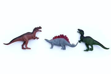 Plastic dinosaur toys on white background. Top view