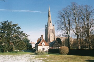 Fototapeta na wymiar Almshouses and St John the Baptist Parish Church, Thaxted, Essex.