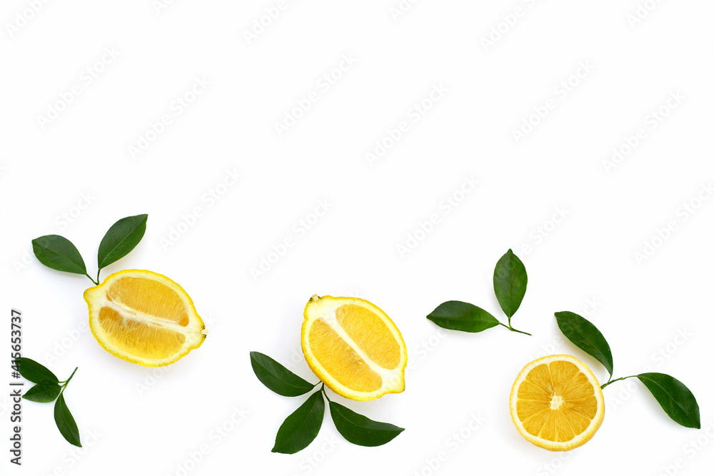 Wall mural fresh lemon with green leaves on white.