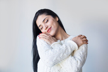 young beautiful woman feeling in love, smiling, cuddling and hugging self, staying single, being...