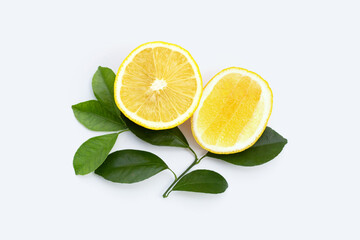 Fresh lemon with green leaves on white.