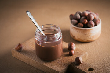 Homemade Chocolate Hazelnut Milk Spread on a brown Background