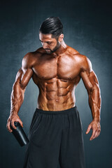 Fototapeta na wymiar Protein Drink. Muscular Men Holding Nutritional Supplement Drink In His Hand