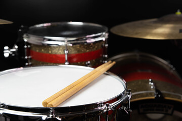 Plakat Closeup of drumsticks lying on the professional drum set. Drummer equipment. 