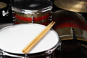 Closeup of drumsticks lying on the professional drum set. Drummer equipment. 