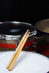 Closeup of drumsticks lying on the professional drum set. Drummer equipment. 