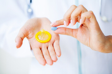 Close up of female doctor holding pill for men health