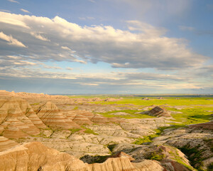 A sweeping landscape view of eroded mountains in Badlands National Park in South Dakota. 