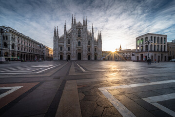 Beautiful scenic picture of Piazza Duomo of Milan Italy at sunrise and sun star