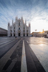 Beautiful geometric picture of Piazza Duomo of Milan at sunrise and sun star