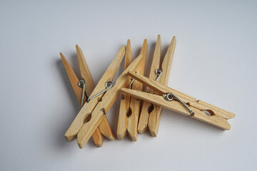 Wooden clothespin isolated on a withe background. The clothespin is a fastener used to dry clothes.