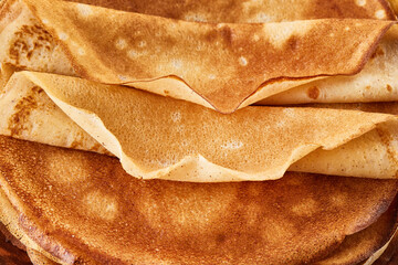 Pancakes. Thin pancakes for breakfast top view. Russian traditional pancakes. East Slavic traditional holiday Maslenitsa. Close-up
