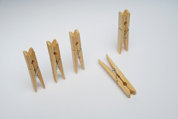 Wooden clothespin isolated on a withe background. The clothespin is a fastener used to dry clothes.