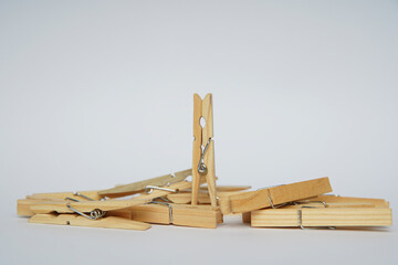 Wooden clothespin isolated on a withe background. The clothespin is a fastener used to dry clothes.