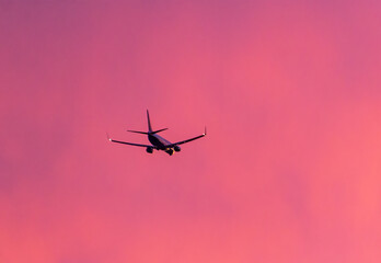 Aeroplane silhouetted against a beautiful sunset.