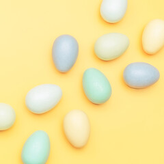 Creative flat lay photo of easter eggs on colorful background.