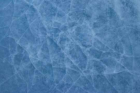 Texture of the cracked ice. Winter background © olyasolodenko