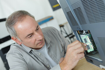 a man fixing a printer