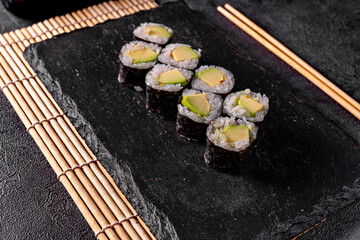 Sushi rolls with avocado and salmon. Classic Japanese sushi. Top view. Free space for your text.